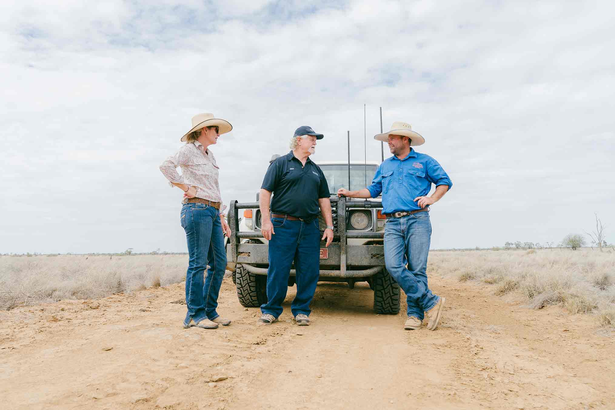 Martin and Beck Eggerling talk with brad Whittington next to white Landcruiser ute