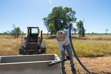 A primary producer installs a new water trough as part of their drought preparedness activities.