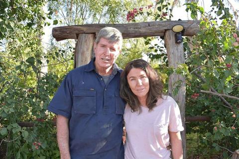 Mark and Sandra Tully standing out the front of their house yard